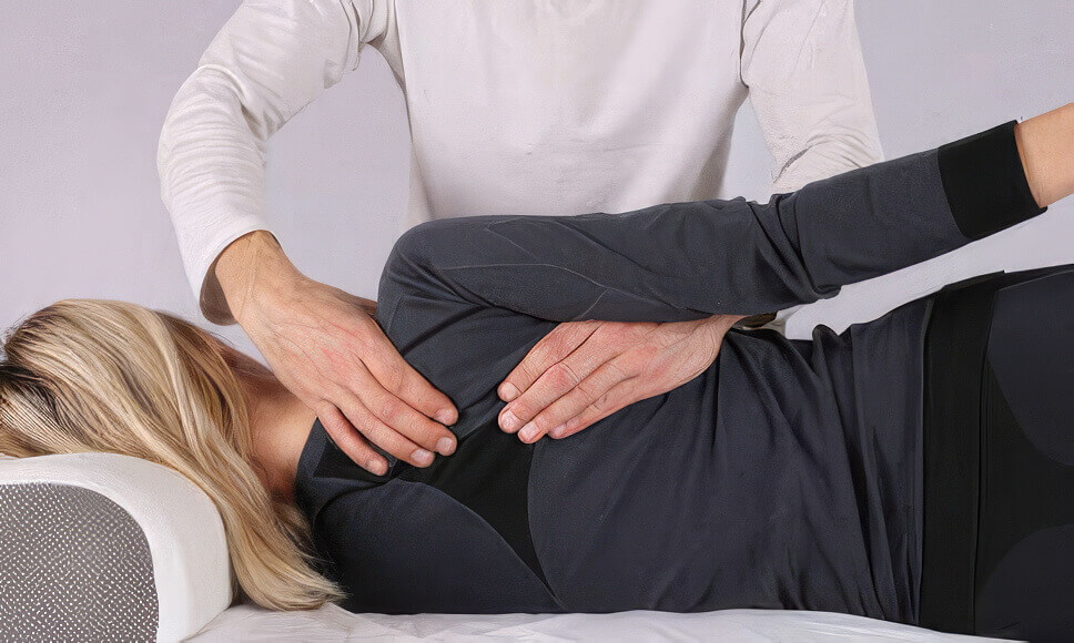 Woman receiving a back adjustment