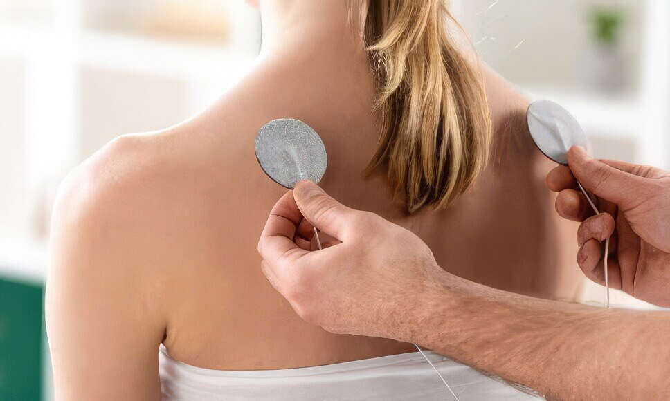 Woman receiving electrotherapy treatment