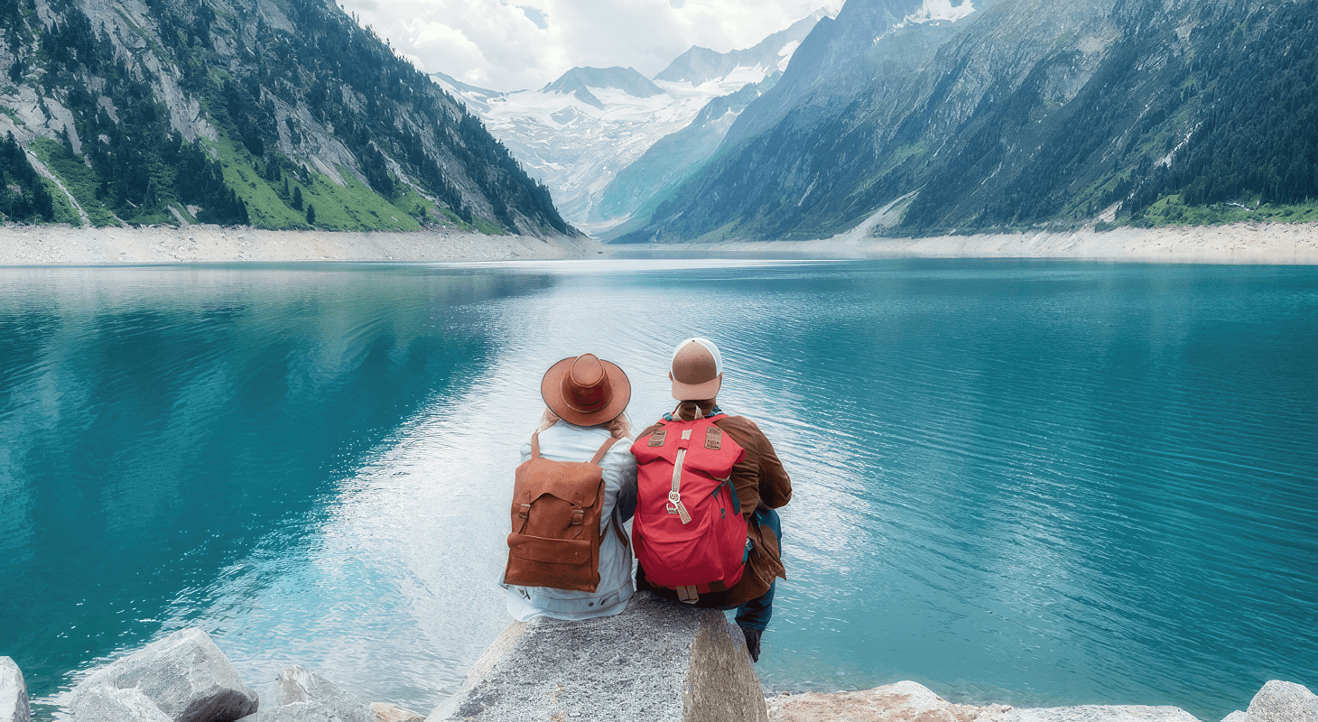 Man and woman sit by lake