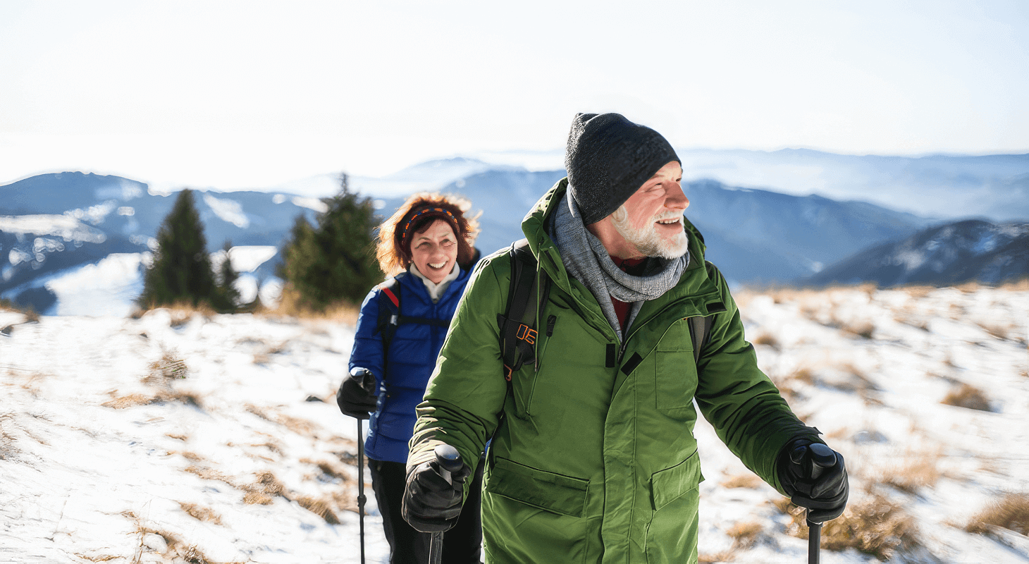 Old couple goes for snowy hike